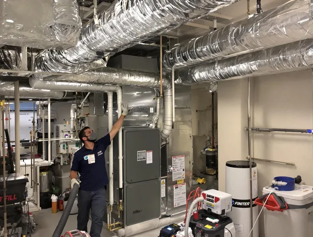 Hopkinton Air Duct Cleaning specialist performing thorough furnace duct cleaning in a Hopkinton residence
