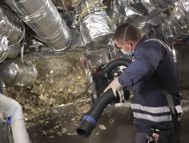 Hopkinton Air Duct Cleaning specialist operating negative pressure cleaning equipment for thorough duct maintenance in Hopkinton