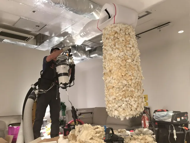 Hopkinton Air Duct Cleaning technician performing precision vacuum insulation removal in a residential property in Hopkinton